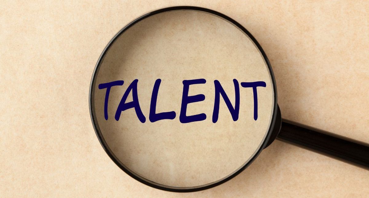 How to Create a Talent Development Strategy 2 talent development strategy talent writing seen with a magnifying glass