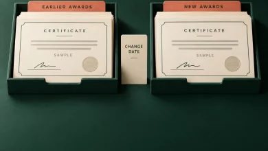 Cream sample certificates in earlier and new award trays with a change date divider on forest green paper